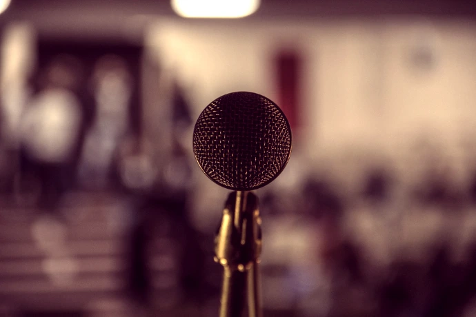 selective focus photography of brass-colored microphone